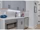 Basement wet bar with gray cabinets, quartz countertops and a wine cooler at 4306 W Barcelona St, Tampa, FL 33629