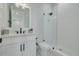 Modern bathroom with white vanity, black fixtures and a glass shower at 4306 W Barcelona St, Tampa, FL 33629