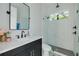 Modern bathroom with subway tile shower, quartz vanity, and black fixtures at 4306 W Barcelona St, Tampa, FL 33629