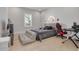 Bedroom with a bed, gaming setup, and a view of the ensuite bathroom at 4306 W Barcelona St, Tampa, FL 33629