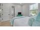 Bedroom with teal bedding, a green dresser, and view into another room at 4306 W Barcelona St, Tampa, FL 33629