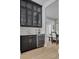Butler's pantry with dark cabinetry, wine cooler, and quartz countertops at 4306 W Barcelona St, Tampa, FL 33629