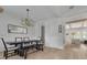 Bright dining room featuring a large table, bench seating, and elegant chandelier at 4306 W Barcelona St, Tampa, FL 33629