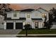 Two-story white house with dark garage doors, illuminated at night at 4306 W Barcelona St, Tampa, FL 33629