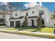 Two-story white house with dark garage doors and landscaping at 4306 W Barcelona St, Tampa, FL 33629