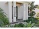 Inviting front porch with a welcoming sign and well-maintained landscaping at 4306 W Barcelona St, Tampa, FL 33629