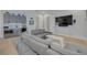 Spacious game room with sectional sofa, wet bar, and arcade game at 4306 W Barcelona St, Tampa, FL 33629