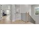 Light-filled hallway with hardwood floors, leading to bedrooms and laundry at 4306 W Barcelona St, Tampa, FL 33629