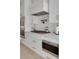 Modern white kitchen with stainless steel appliances and gold accents at 4306 W Barcelona St, Tampa, FL 33629