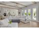 Spacious living room with white sectional sofa and hardwood floors at 4306 W Barcelona St, Tampa, FL 33629