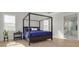 Main bedroom with four-poster bed and ensuite bathroom access at 4306 W Barcelona St, Tampa, FL 33629