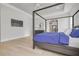 Main bedroom with four-poster bed, hardwood floors, and access to bathroom at 4306 W Barcelona St, Tampa, FL 33629
