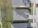 Aerial view of a house with gray roof and driveway at 4661 Southern Valley Loop, Brooksville, FL 34601