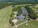 Aerial view of a golf course community with clubhouse and parking at 4661 Southern Valley Loop, Brooksville, FL 34601