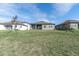 Spacious backyard with grassy lawn and partial view of neighboring houses at 4661 Southern Valley Loop, Brooksville, FL 34601
