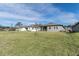 Large backyard with grassy area and a view of homes and trees at 4661 Southern Valley Loop, Brooksville, FL 34601