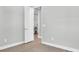 Simple bedroom with wood-look floors and white doors at 4661 Southern Valley Loop, Brooksville, FL 34601
