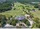 Aerial view of a clubhouse near a lush green golf course at 4661 Southern Valley Loop, Brooksville, FL 34601