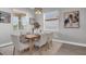 Dining room with wood table, neutral chairs, and natural light at 4661 Southern Valley Loop, Brooksville, FL 34601