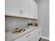 White kitchen cabinets and quartz countertop wet bar at 4661 Southern Valley Loop, Brooksville, FL 34601