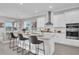 Modern kitchen with white cabinets, stainless steel appliances, and an island at 4661 Southern Valley Loop, Brooksville, FL 34601