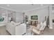 Living room with light beige sofas, a coffee table, and a large TV at 4661 Southern Valley Loop, Brooksville, FL 34601