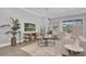 Living room with beige sofa, coffee table, and sliding glass doors to patio at 4661 Southern Valley Loop, Brooksville, FL 34601