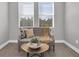 Cozy sitting area featuring a gray sofa and a wooden coffee table at 4661 Southern Valley Loop, Brooksville, FL 34601