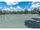 Well-maintained tennis courts with surrounding fencing and landscaping at 4661 Southern Valley Loop, Brooksville, FL 34601