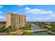 Aerial view of a highrise building near a canal with boats and lush greenery at 4900 Brittany S Dr # 409, St Petersburg, FL 33715