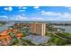 Aerial view of a waterfront highrise building with parking and surrounding landscape at 4900 Brittany S Dr # 409, St Petersburg, FL 33715