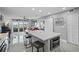 Open concept kitchen with island and breakfast bar, flows into living area at 4900 Brittany S Dr # 409, St Petersburg, FL 33715