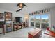 Living room with sliding glass doors leading to balcony and water views at 4900 Brittany S Dr # 409, St Petersburg, FL 33715