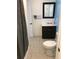 Bathroom with dark vanity, shower, and tiled floor at 501 180Th E Ave, Redington Shores, FL 33708