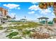 Beachfront view with picnic tables and benches at 501 180Th E Ave, Redington Shores, FL 33708