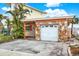 Attached garage with stone exterior and white door at 501 180Th E Ave, Redington Shores, FL 33708