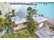 Charming waterfront home with pink exterior and lush landscaping at 501 180Th E Ave, Redington Shores, FL 33708