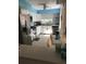 Kitchen with white cabinets, stainless steel appliances, and light tile floors at 501 180Th E Ave, Redington Shores, FL 33708