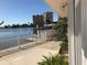 Waterfront patio with white railing and canal view at 501 180Th E Ave, Redington Shores, FL 33708