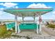 Beachfront picnic area with covered tables and benches at 501 180Th E Ave, Redington Shores, FL 33708