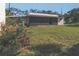 Spacious backyard featuring a large grassy area and mature trees, offering plenty of room for outdoor activities at 509 Rosery Nw Rd, Largo, FL 33770