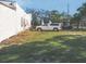 Expansive backyard with ample space for parking vehicles on a grassy lawn at 509 Rosery Nw Rd, Largo, FL 33770