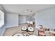 Bright living room with tile flooring, a ceiling fan, and access to kitchen at 5810 Ne Venetian Blvd, St Petersburg, FL 33703