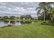 Landscaped backyard with lake access at 6002 Shearwater Ln, Lithia, FL 33547