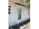 Back exterior with white walls and a door needing paint at 615 Newton S Ave, St Petersburg, FL 33701