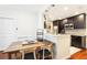 Modern kitchen with dark cabinetry, granite countertops, and breakfast bar at 700 S Harbour Island Blvd # 226, Tampa, FL 33602