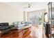 Bright living room with hardwood floors, sectional sofa, and large window at 700 S Harbour Island Blvd # 226, Tampa, FL 33602
