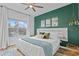 Main bedroom with a king-size bed and green accent wall at 809 Normandy Trace Rd, Tampa, FL 33602