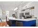 Modern kitchen with white cabinets and a blue breakfast bar at 809 Normandy Trace Rd, Tampa, FL 33602