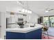 Modern kitchen with white cabinets and a blue breakfast bar at 809 Normandy Trace Rd, Tampa, FL 33602